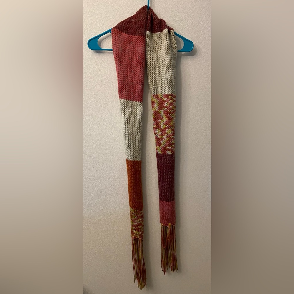 Knit multicolored scarf with end tassels. 100% Acrylic. 76inches.